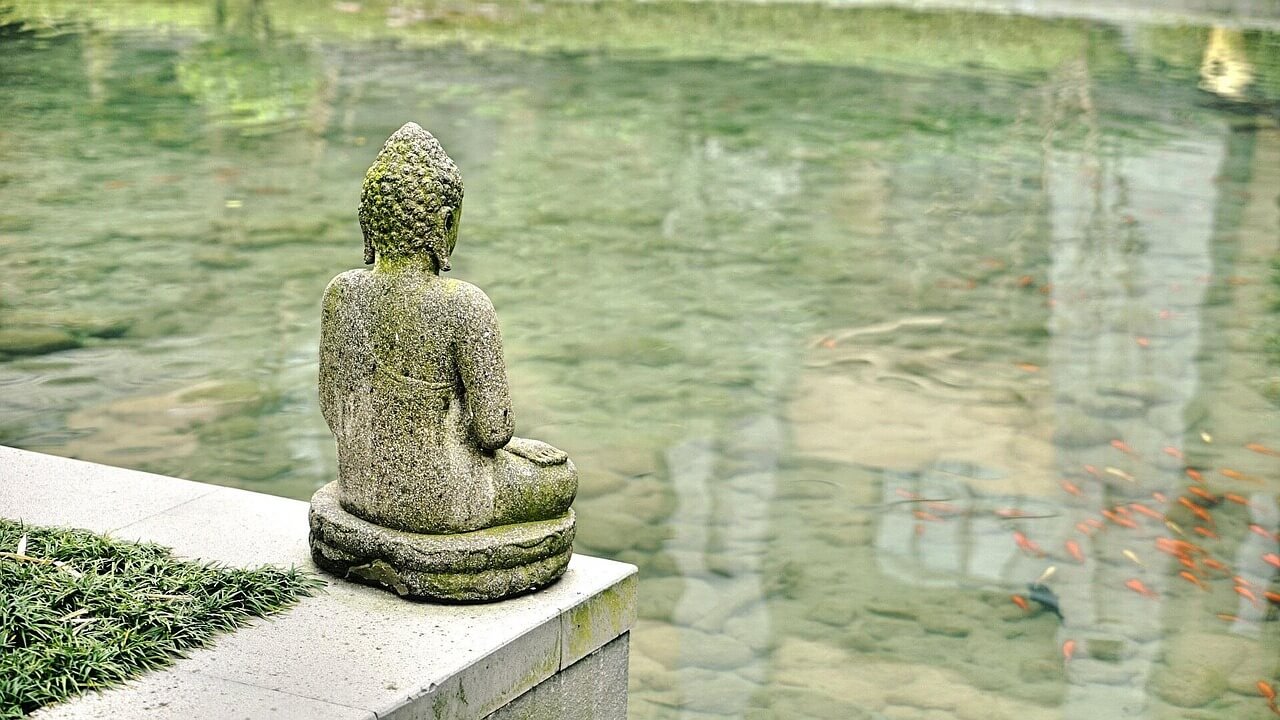 Monk pouring water from plate